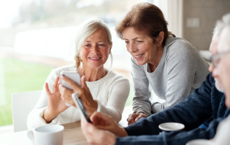 Familienmitglieder schauen gemeinsam auf ein Smartphone